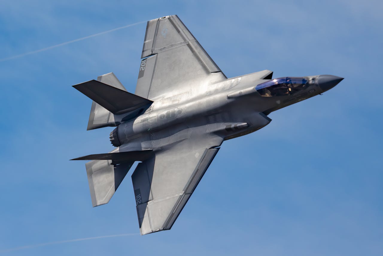 The Art of Drawing Readers In: Your attractive post title goes here F-35 Lightning II fighter jet soaring through a clear blue sky.