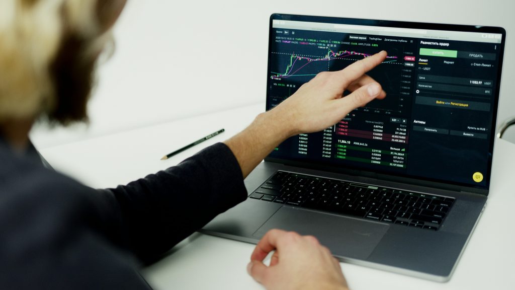 pexels-photo-5716052-5716052 A person analyzing stock market graphs on a laptop screen, showcasing trading insights.